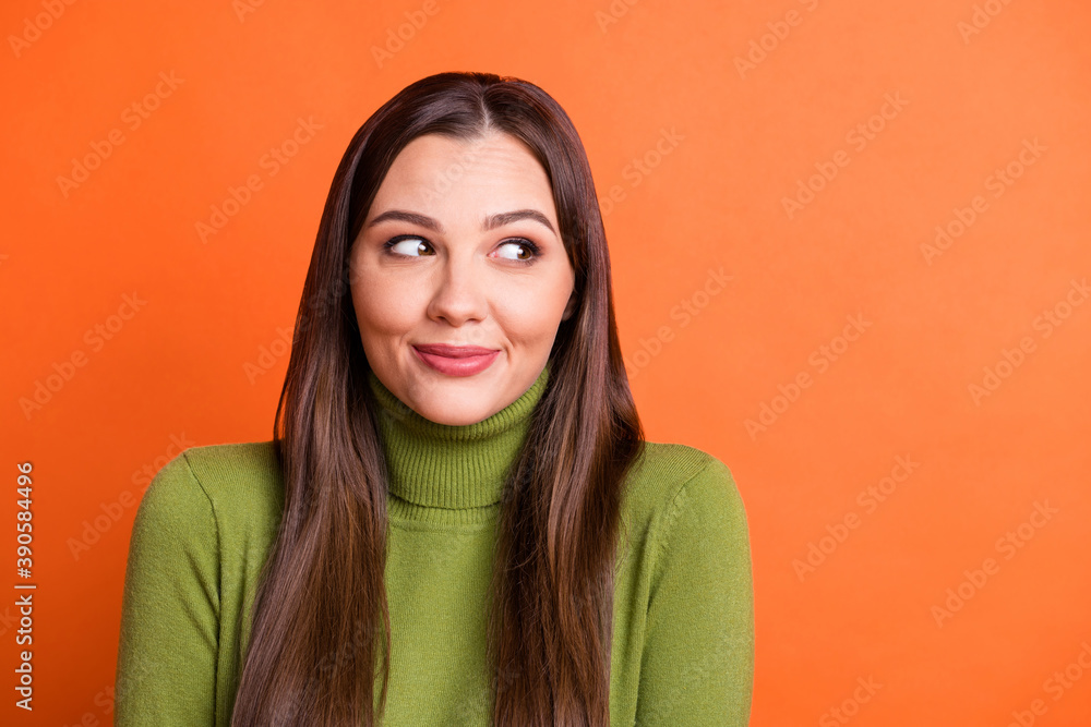 Portrait of optimistic sweet brunette hairdo girl look empty space wear green sweater isolated on pumpkin color background Portrait of optimistic sweet brunette hairdo girl look empty space wear green sweater isolated on pumpkin color background