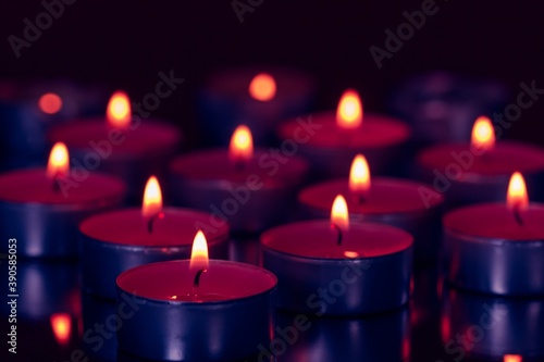 Several small burning candles. The atmosphere of a holiday, love, romance.