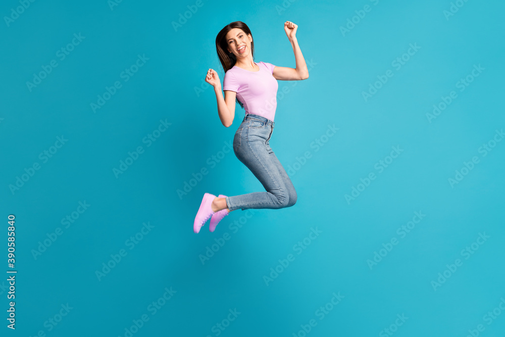 Full length photo of cheerful brunette hair woman girl dressed casual violet t-shirt jumping high isolated blue color background