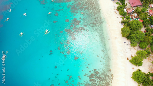 Beautiful tropical beach with turquoise water on a tropical island. Alorro Beach, Philippines, Samal. © Alex Traveler
