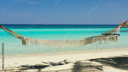 Tropical landscape: beautiful beach with hammock and tropical sea. Panglao island, Bohol, Philippines. Summer and travel vacation concept. photo