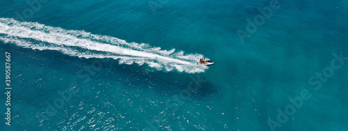 Aerial drone ultra wide photo of jet ski watercraft cruising in high speed in deep blue open ocean sea