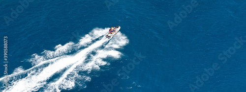 Aerial drone ultra wide photo of jet ski watercraft cruising in high speed in deep blue open ocean sea © aerial-drone