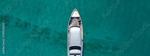 Aerial drone ultra wide photo of luxury yacht with wooden deck anchored in tropical exotic island bay wit turquoise sea © aerial-drone