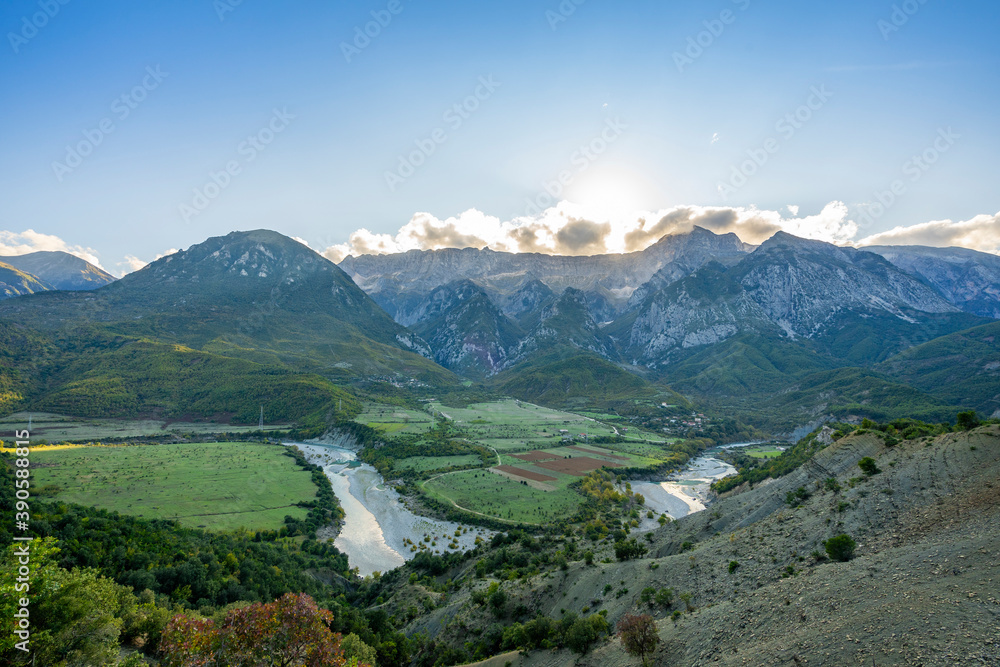 Beautiful sunrise over wild forest, mountains in summer