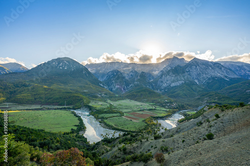 Beautiful sunrise over wild forest, mountains in summer