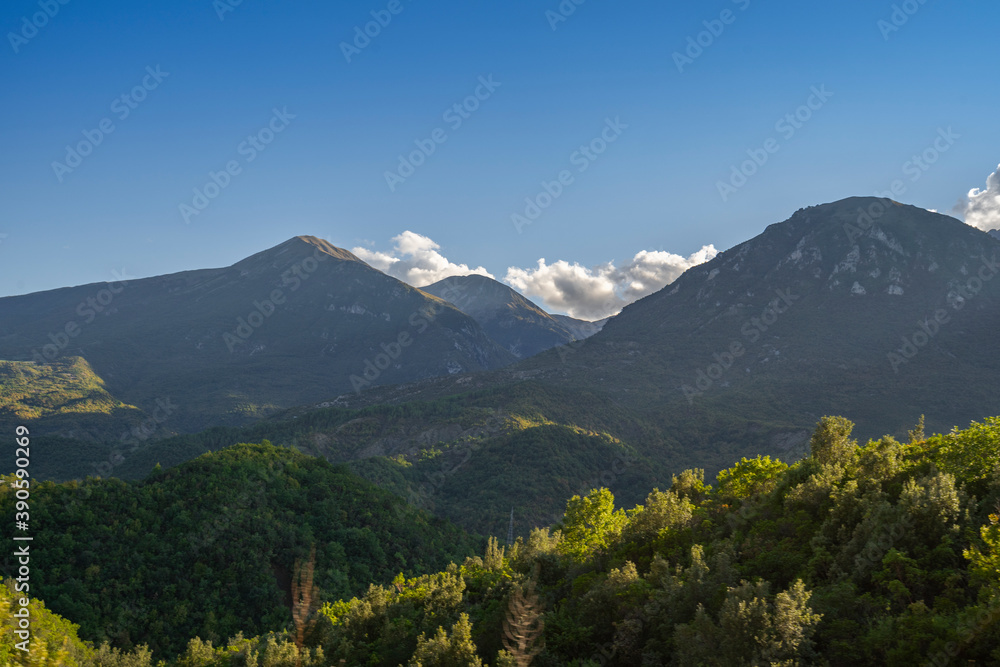 Beautiful sunrise over wild forest, mountains in summer