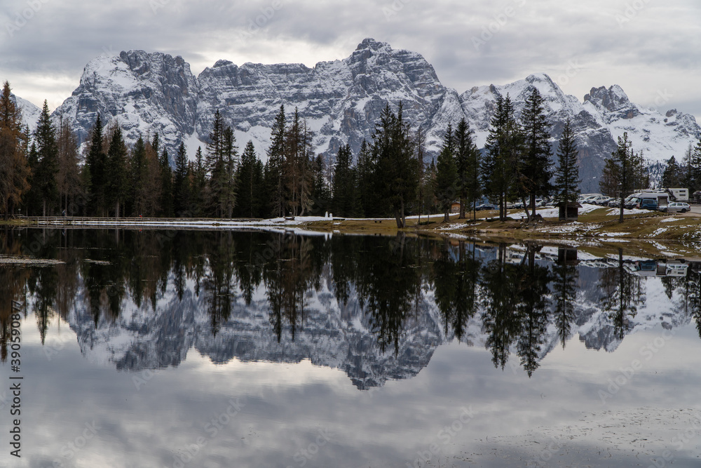 Photo of a lake that reflects the whole mountain in the background.