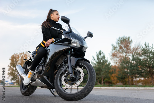 Stylish biker girl on motorcycle