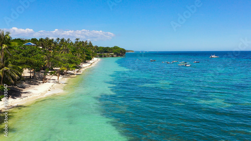 Fototapeta Naklejka Na Ścianę i Meble -  Beautiful tropical beach and turquoise water view from above. Alona beach, Panglao, Philippines. Summer and travel vacation concept.