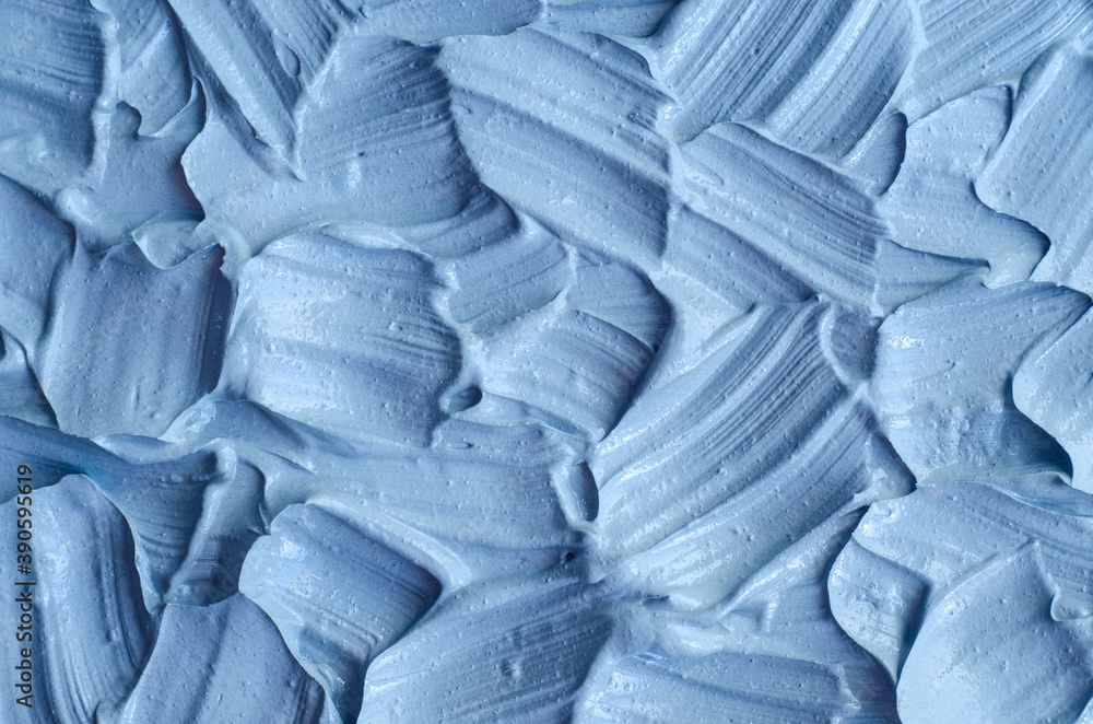 Obraz premium Light blue bentonite facial clay (alginate mask, face cream, body wrap) texture close up, selective focus. Abstract background with brush strokes.