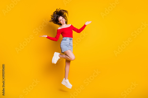 Fototapeta Naklejka Na Ścianę i Meble -  Full length body size view of her she nice attractive charming cheerful cheery thin girl jumping having fun spending weekend isolated bright vivid shine vibrant yellow color background