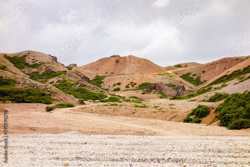 Icelandic landscape with red and orange hills in Lonsoraefi in overcast weather