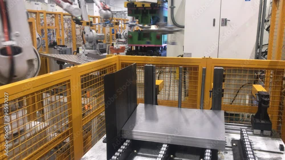 Robot car factory. Steel metal production with machine on automotive manufacture plant. Industry technology.Bending sheet metal with a hydraulic machine. Robot car factory. Steel metal production with machine on automotive manufacture plant. Industry technology.Bending sheet metal with a hydraulic machine.