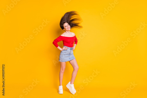 Full length body size view of her she nice attractive fashionable thin slender cheerful teen girl throwing healthy hair having fun isolated over bright vivid shine vibrant yellow color background