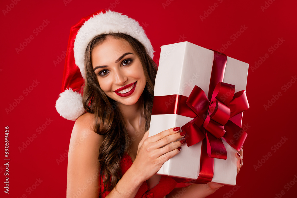 Photo of pretty cheerful snow maiden hands hold present have good mood isolated on red color background Photo of pretty cheerful snow maiden hands hold present have good mood isolated on red color background