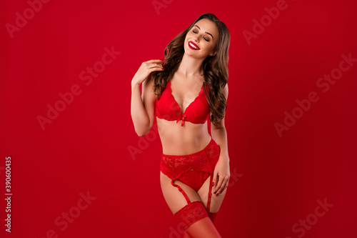 Photo of attractive lover lady closed eyes hand touch hair enjoy nice underwear isolated on red color background © deagreez