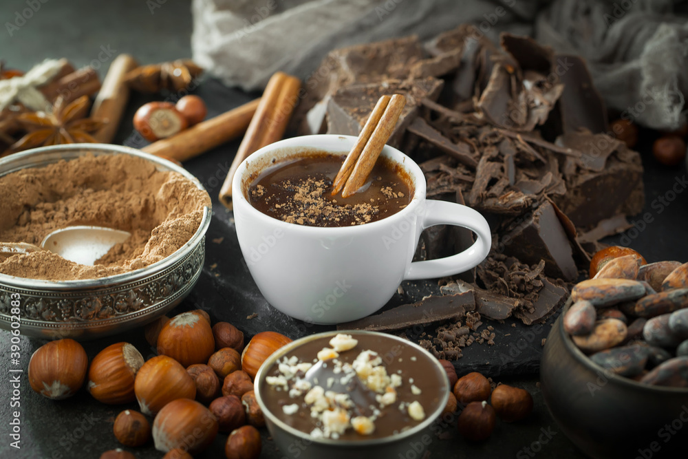 Hot chocolate on an old background in a composition with cocoa beans and nuts. Hot chocolate on an old background in a composition with cocoa beans and nuts.