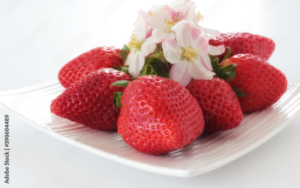 Intensive red strawberries on a white plate. Intensive red strawberries on a white plate.