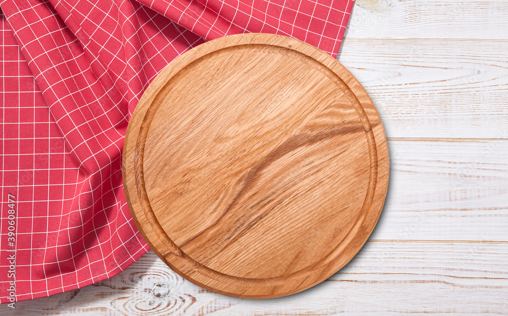 Empty pizza board and red napkin on white wooden