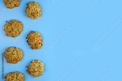 homemade oatmeal cookies with raisins on a blue background. Copy space for text