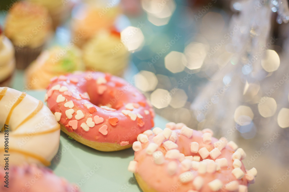 Bright donut in a pink glaze on festive background. Bright donut in a pink glaze on festive background.