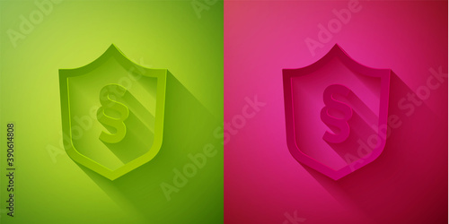Paper cut Justice law in shield icon isolated on green and pink background. Paper art style. Vector.
