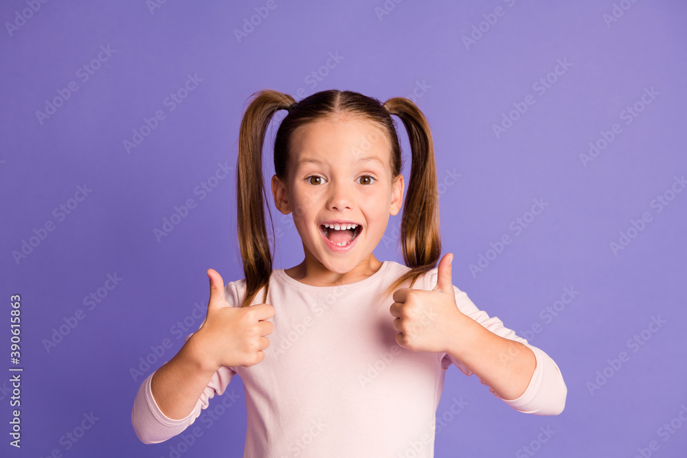 Photo of attractive brown haired pigtails girl show thumbs up recommend isolated on violet color background Photo of attractive brown haired pigtails girl show thumbs up recommend isolated on violet color background