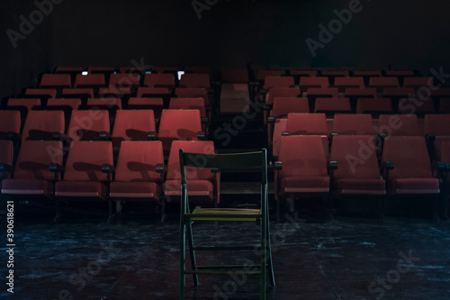 empty chair in front of theater seats