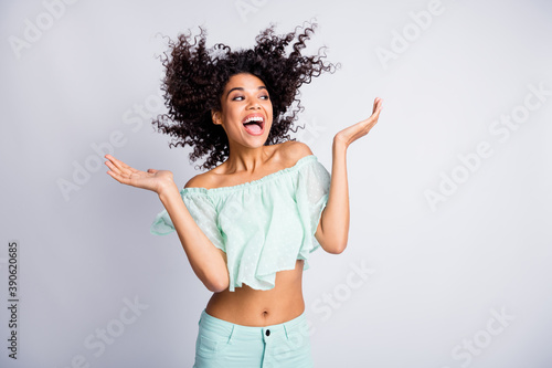 Photo portrait of excited laughing girl with flying hair isolated on white colored background