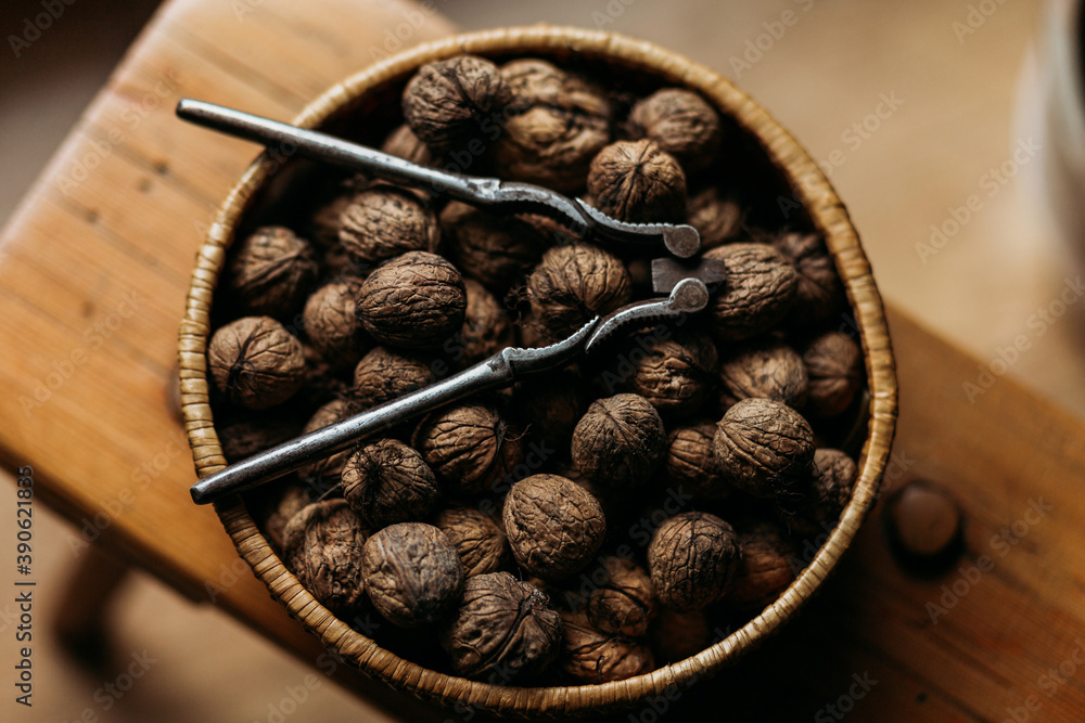 walnuts in wooden bowl closeup with walnut opener walnuts in wooden bowl closeup with walnut opener