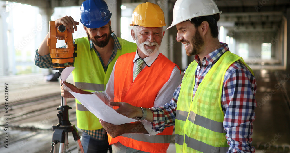 Architect and construction engineer or surveyor discussion plans and blueprints Architect and construction engineer or surveyor discussion plans and blueprints