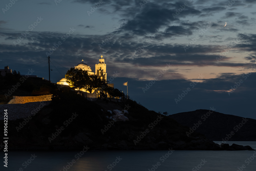 Obraz premium View of the Agia Irini, Saint Irene, Greek Orthodox church at night. Beautiful illumination, Chora, Ios, Greece.