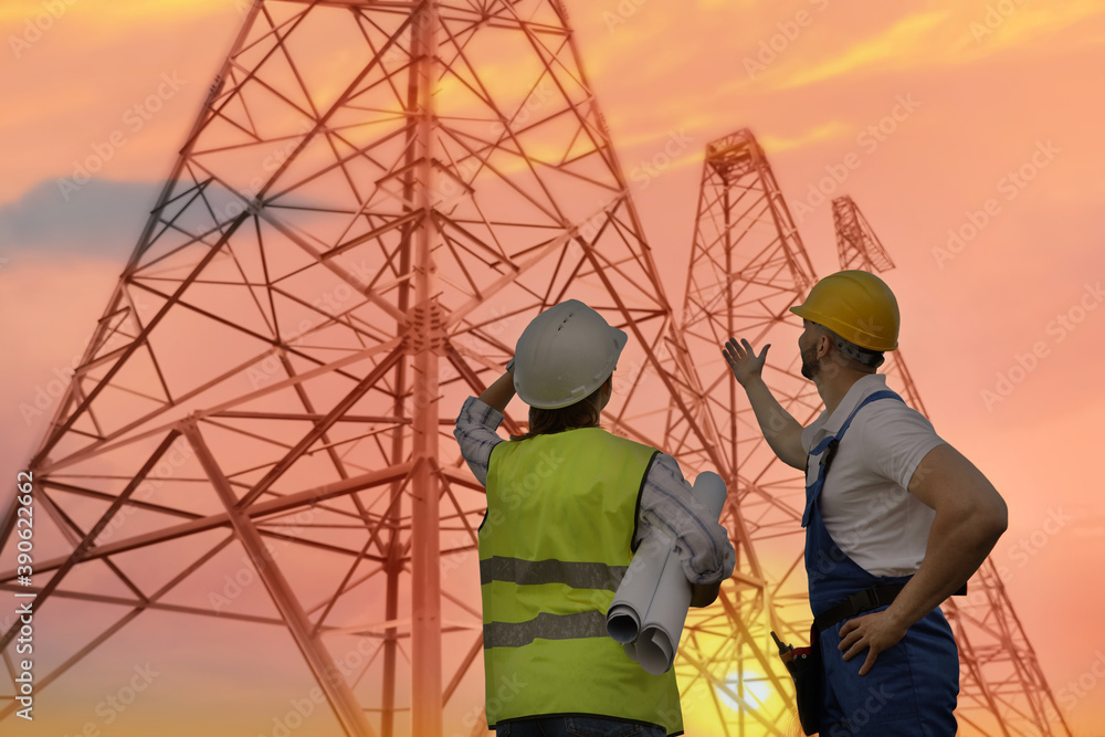 Professional engineers working on installation of electrical substation outdoors Professional engineers working on installation of electrical substation outdoors
