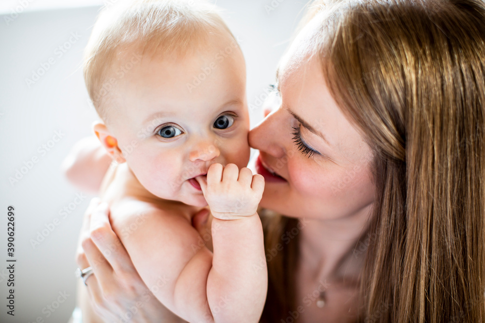 Portrait of baby being held by woman, looking at camera Portrait of baby being held by woman, looking at camera
