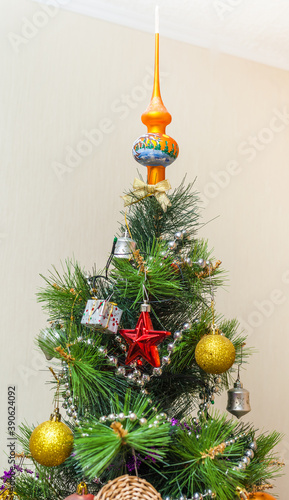 Christmas artificial tree decorated with toys