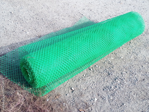 green plastic mesh in a roll for fencing