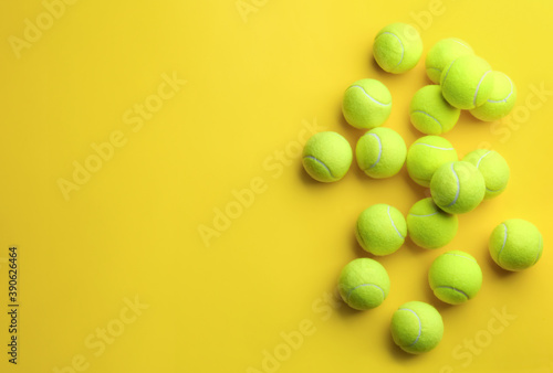 Tennis balls on yellow background, flat lay. Space for text © New Africa