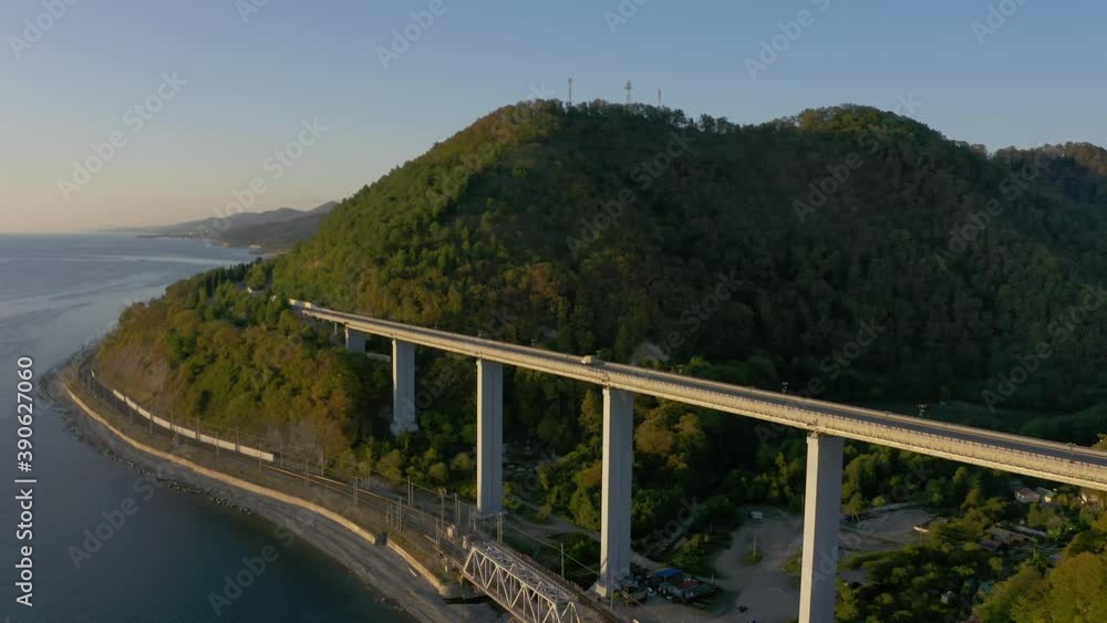 Beautiful large bridge for motorway across sea, aerial view of drone slide turn, beautiful design of the automotive bridge. Travel. Flying Over Bridge as Cars Pass. Sochi, Russia Beautiful large bridge for motorway across sea, aerial view of drone slide turn, beautiful design of the automotive bridge. Travel. Flying Over Bridge as Cars Pass. Sochi, Russia