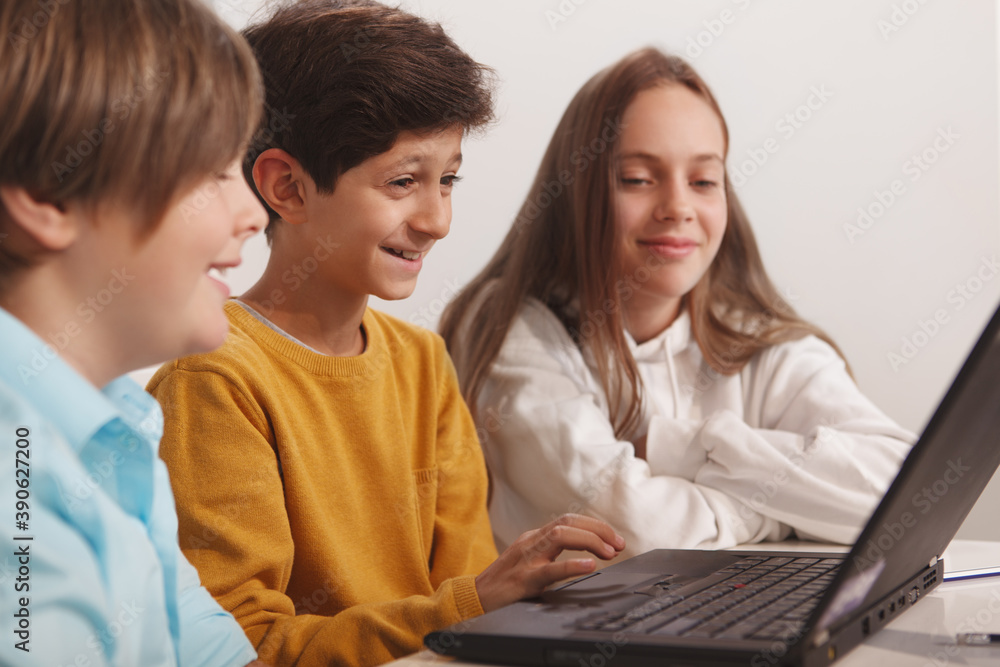 Group of happy kids having fun studying together at computer school Group of happy kids having fun studying together at computer school