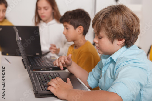 Kids working on laptop at computer school, copy space