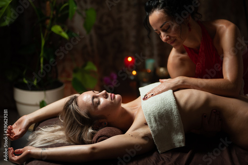 Beautiful young woman having visceral massage in spa center