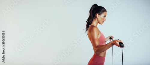 Fototapeta Naklejka Na Ścianę i Meble -  Portrait of a fitness woman with skipping rope