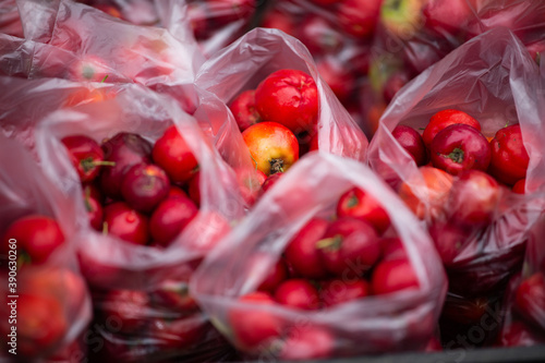 Closeup of red fruits and vegetables in plastic bags