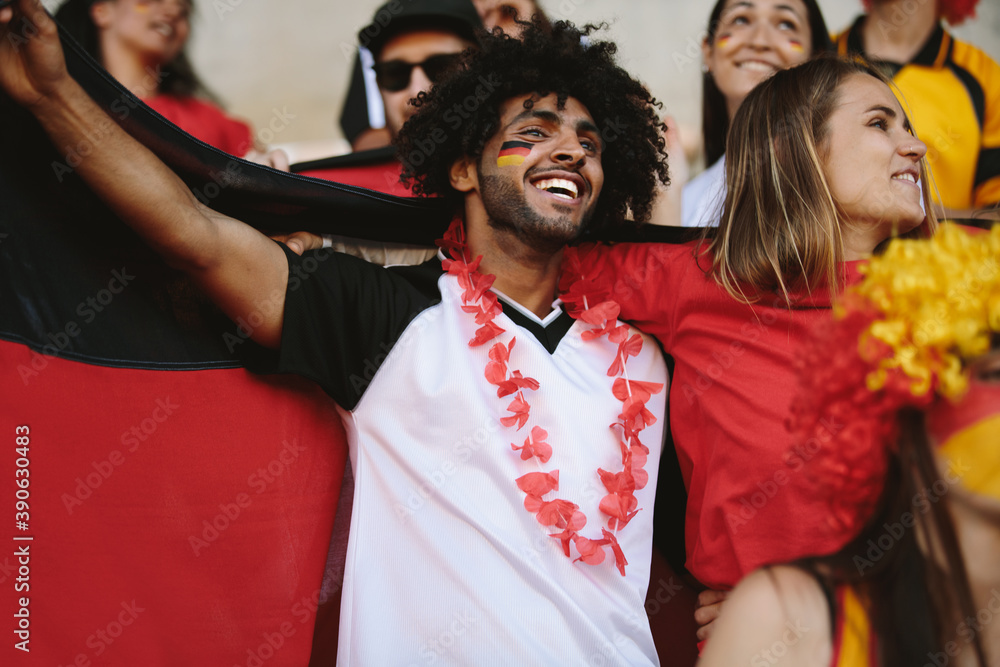 Group of german soccer fans cheering in stadium