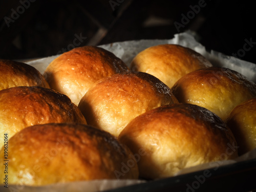 Golden brown bread rolls in dark food photography style