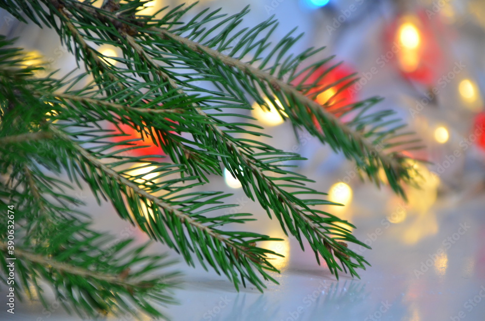 branch of a Christmas tree on a background of Christmas lights new year background, no focus, blur, blurry Closeup of Christmas tree background