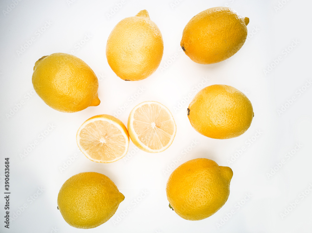 Top view on fresh colorful and juicy lemons. Lemons cut in half on the white background.