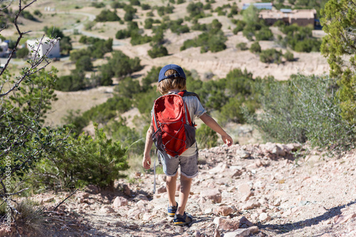 4 year old boy hiking in rural landscape, Lamy, New Mexico. photo