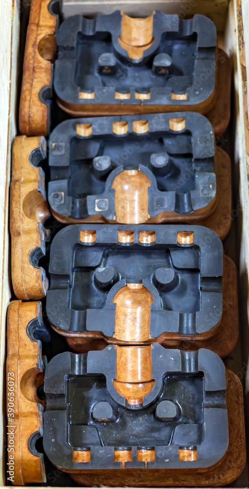 Folded into a wooden box of semi-body of pressed material arc suppression chamber with non-stick coating closeup Folded into a wooden box of semi-body of pressed material arc suppression chamber with non-stick coating closeup